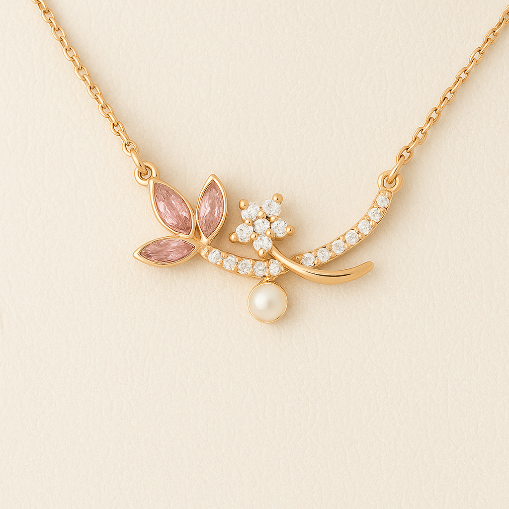 Gold necklace with pink gemstones and a pearl on a beige background
