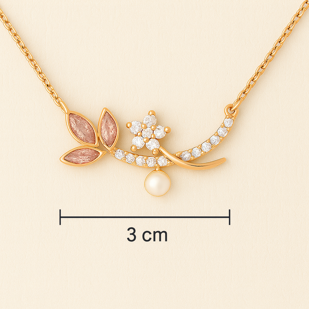 Gold necklace with leaf and pearl pendant on a beige background