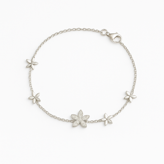 Silver bracelet with floral designs on a white background