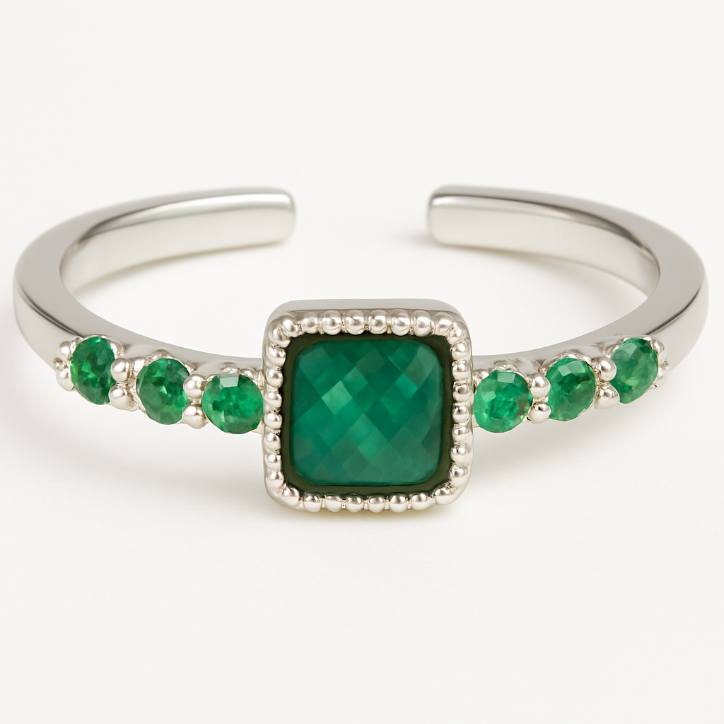 Silver open ring with a green gemstone on a white background