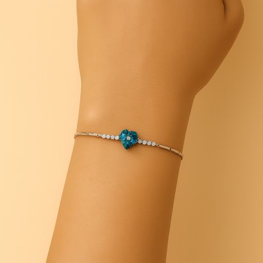 Bracelet with a blue flower design on a wrist against a beige background