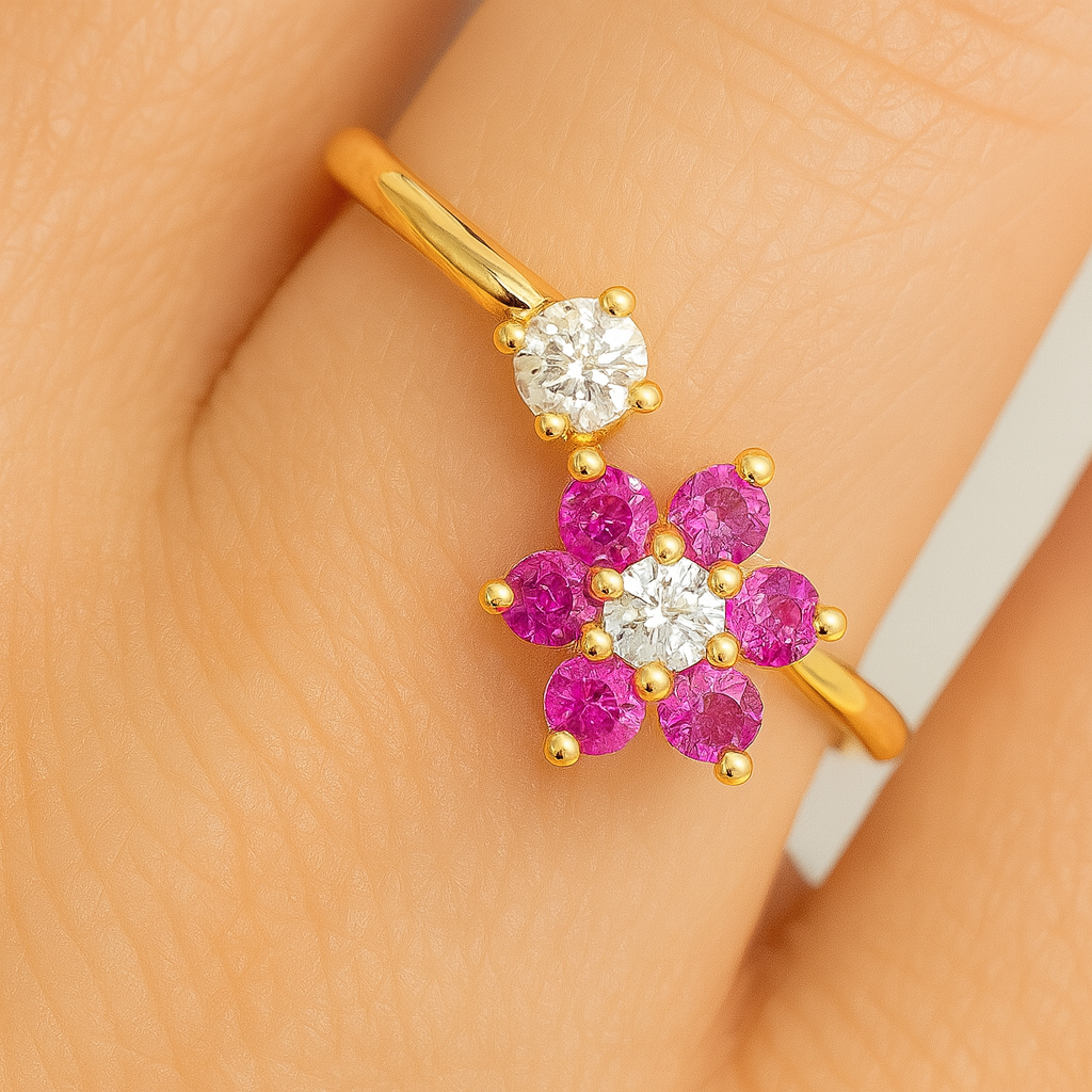 Gold earring with pink gemstones on a hand