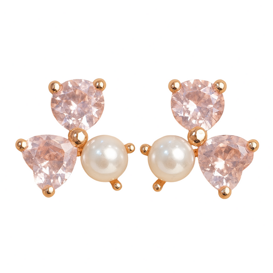 Pair of earrings with pink gemstones and pearls on a beige background