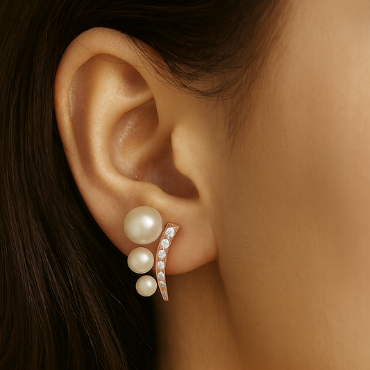 Close-up of an ear wearing a pearl earring with a blurred background