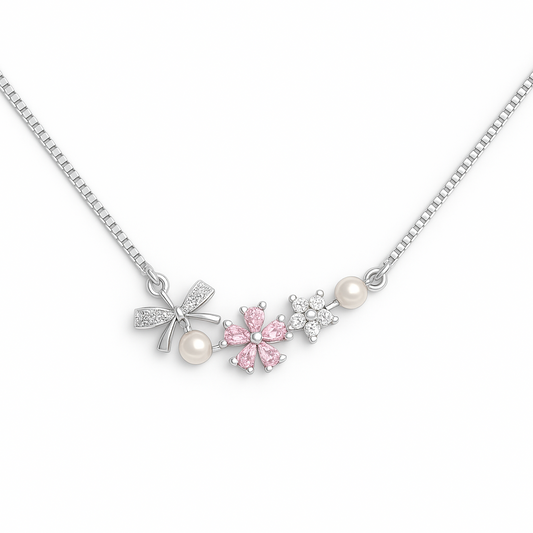 Necklace with floral and bow-shaped pendants on a white background