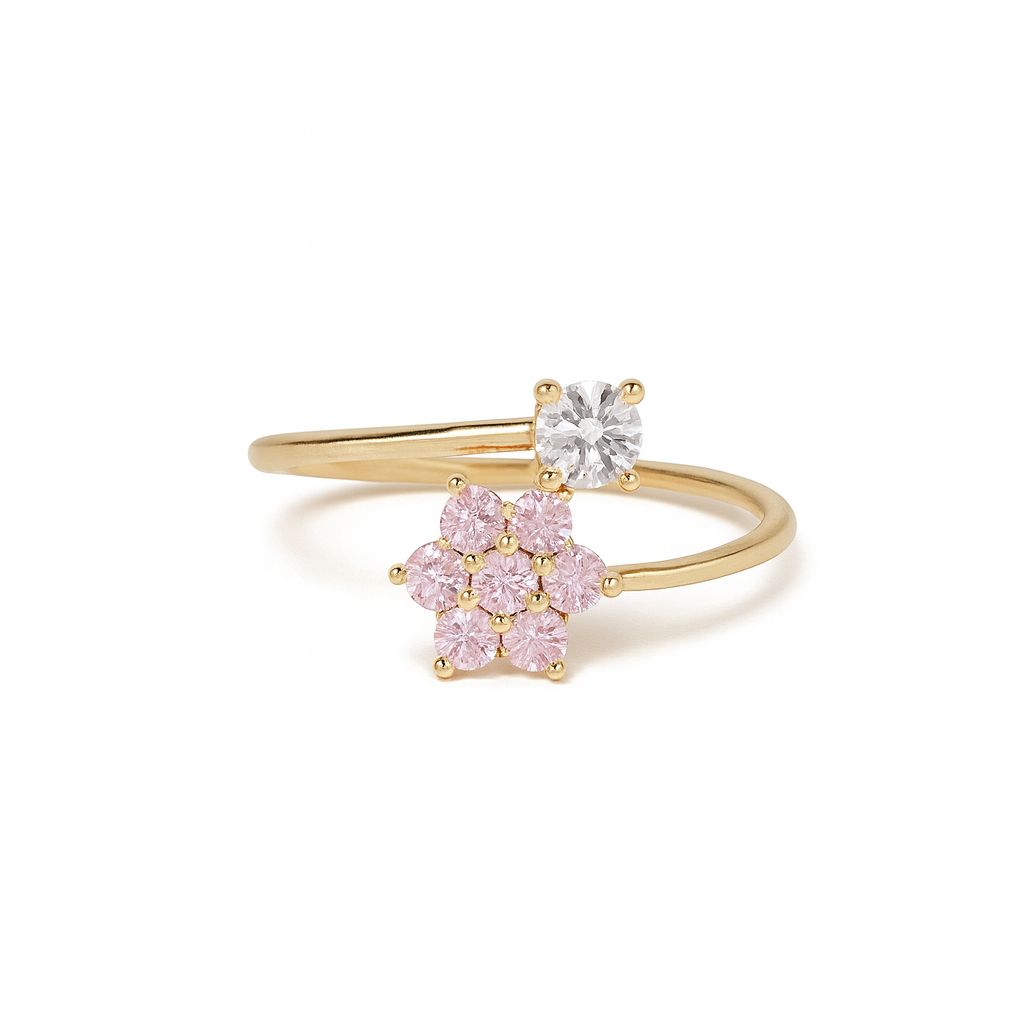 Gold ring with pink gemstones and a central diamond on a white background
