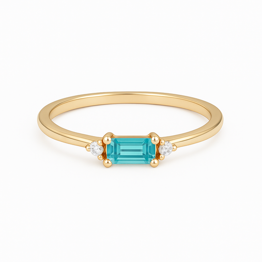Gold ring with a aquamarine gemstone on a white background