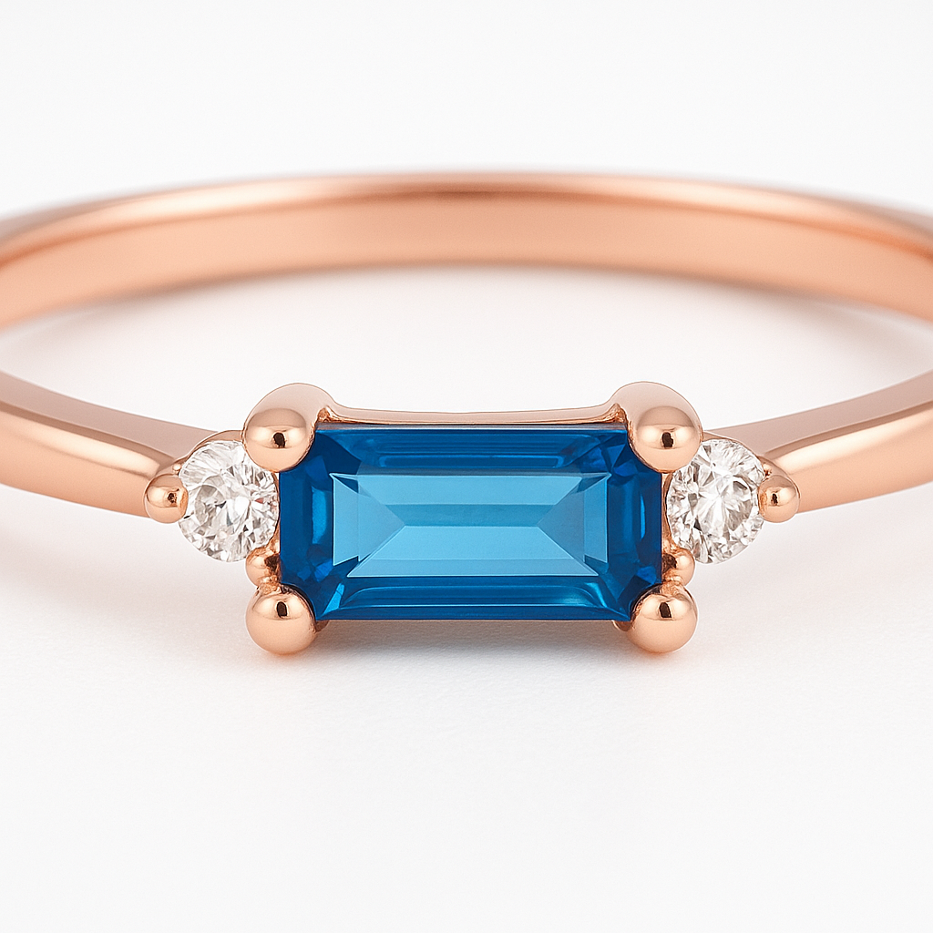 Rose gold ring with a blue gemstone and smaller diamonds on a white background