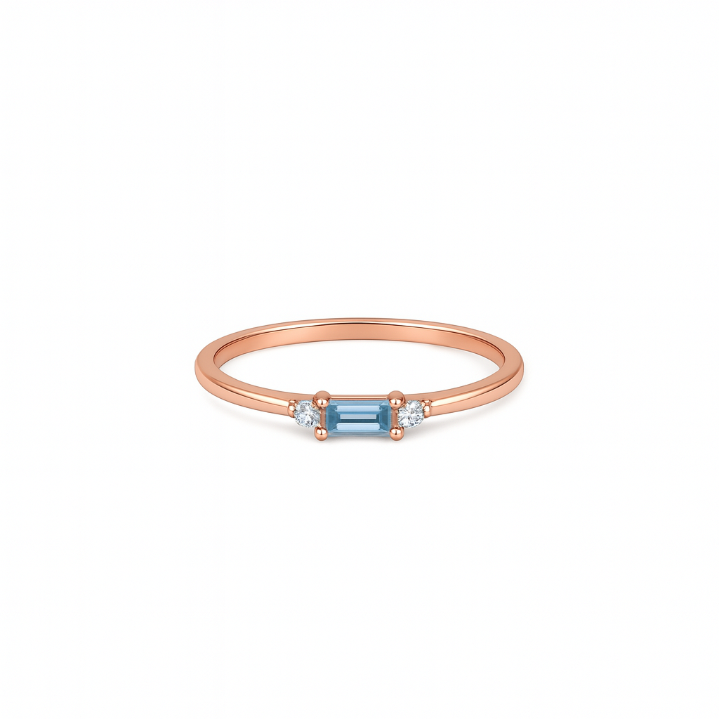 Rose gold ring with a blue gemstone on a white background