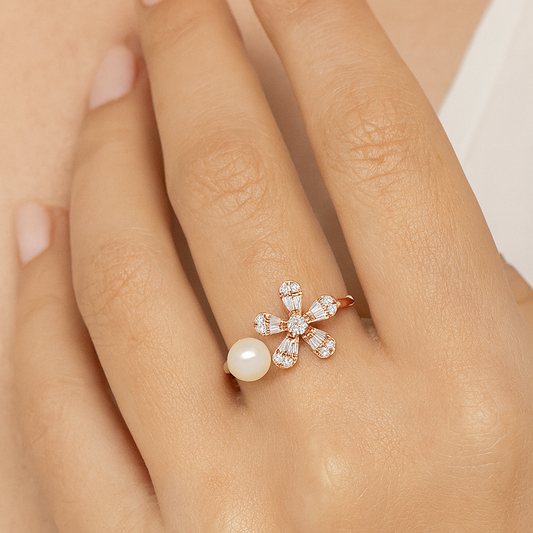 Rose gold ring with a pearl and diamonds on a hand against a neutral background
