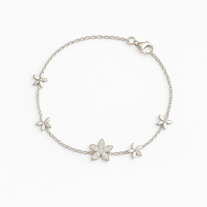 Silver bracelet with floral designs on a white background