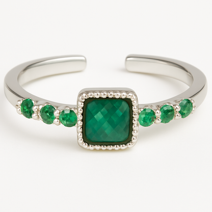 Silver open ring with a green gemstone on a white background
