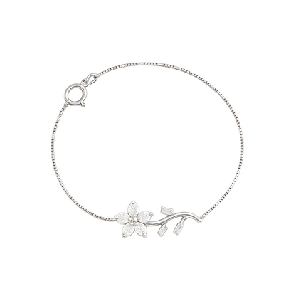 Silver bracelet with floral design on a white background