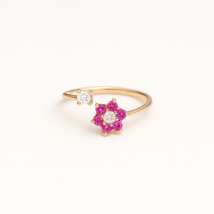 Gold ring with pink gemstones on a white background