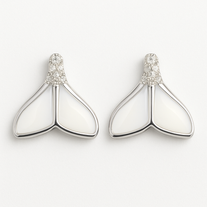 Pair of silver earrings with white stones on a light gray background