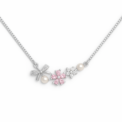 Necklace with floral and bow-shaped pendants on a white background